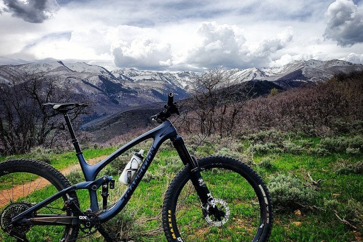 a bicycle parked on a grassy hill