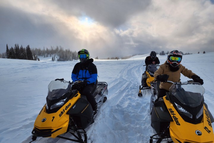 a couple of people that are sitting in the snow